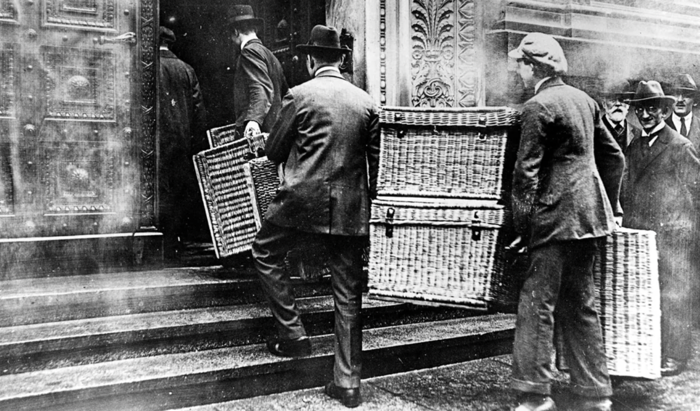 Germans use laundry baskets to collect their bulky pay packets during the Weimar Republic, Berlin, 1923.