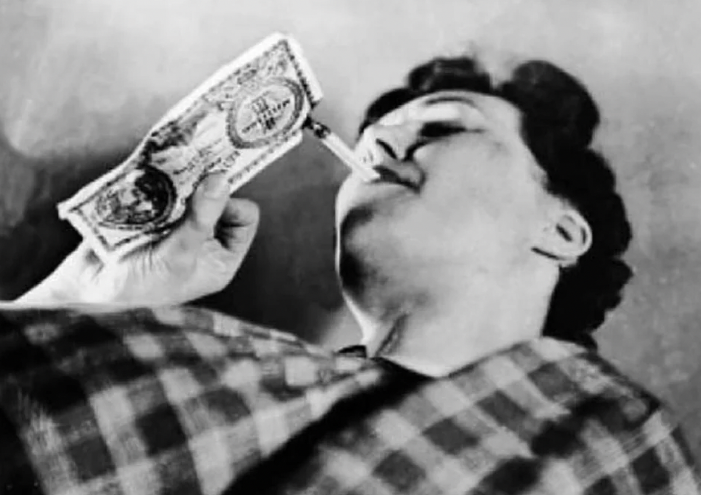 A woman uses paper money to ignite her cigarette during the Hungarian Hyperinflation, 1946.