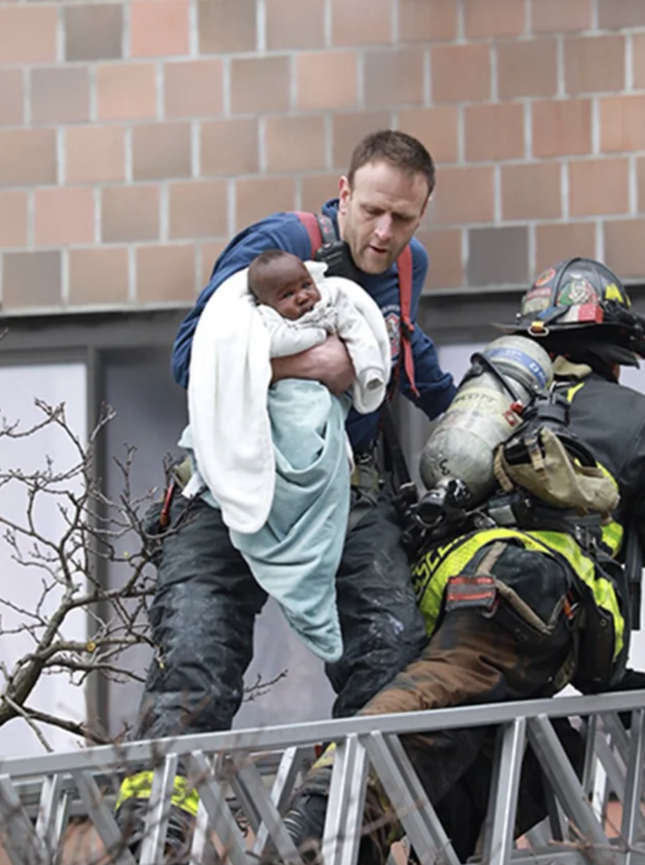 A Bronx firefighter saving a baby from a massive two alarm fire.