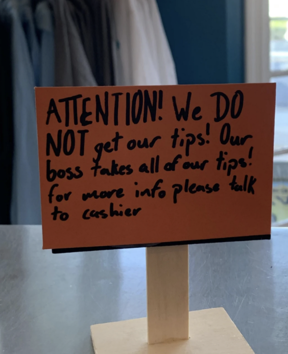 signage - Attention! We Do get our tips! Our Not get boss fakes all of our tips! for more info please talk to cashier