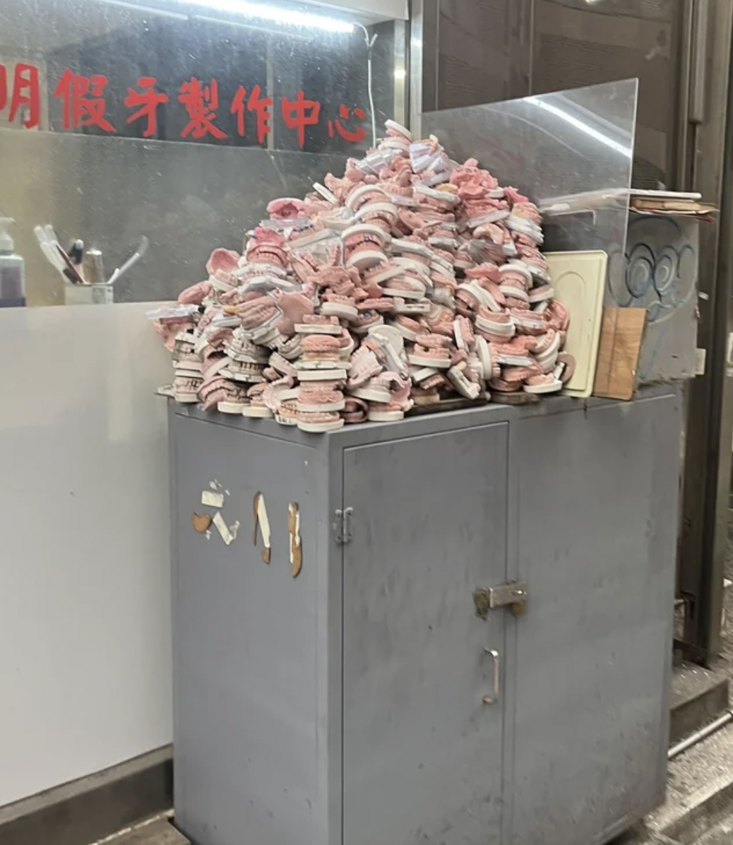 “A pile of dentures on the side of the street in Taipei, Taiwan.”