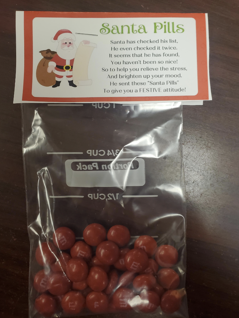 chocolate-covered raisin - Santa Pills Santa has checked his list, He men checked it twice. It seems that he has found, You haven't been so nice! So to help you relieve the stress And brighten up your mood He sent these "Santa Pills" To give you a Festive