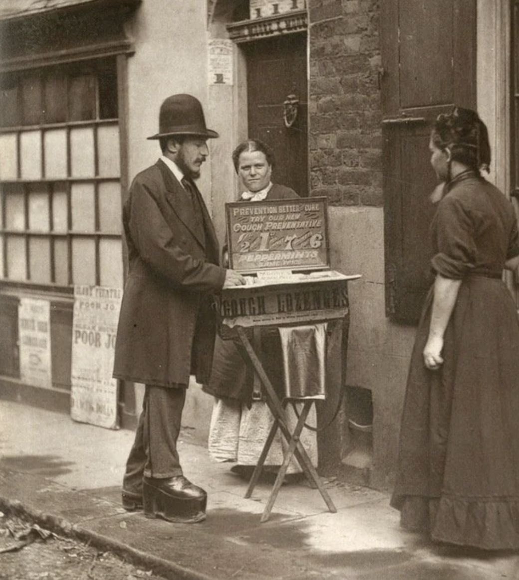 A street doctor vendor of cough lozenges and healing ointment, London, England, 1877.