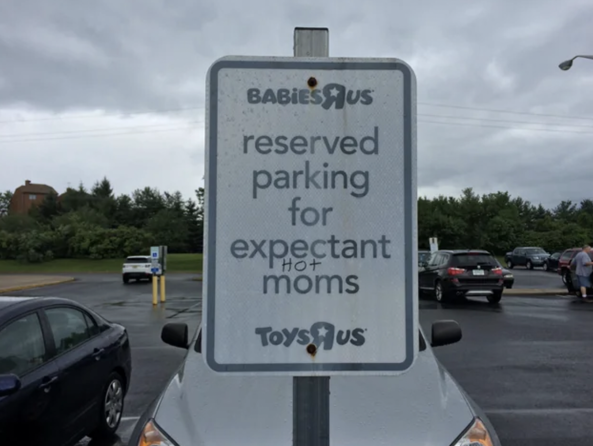 street sign - Babiesus reserved parking for expectant moms Toys Us