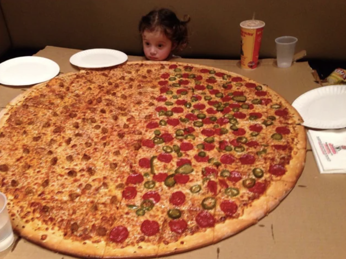 little girl with giant pizza