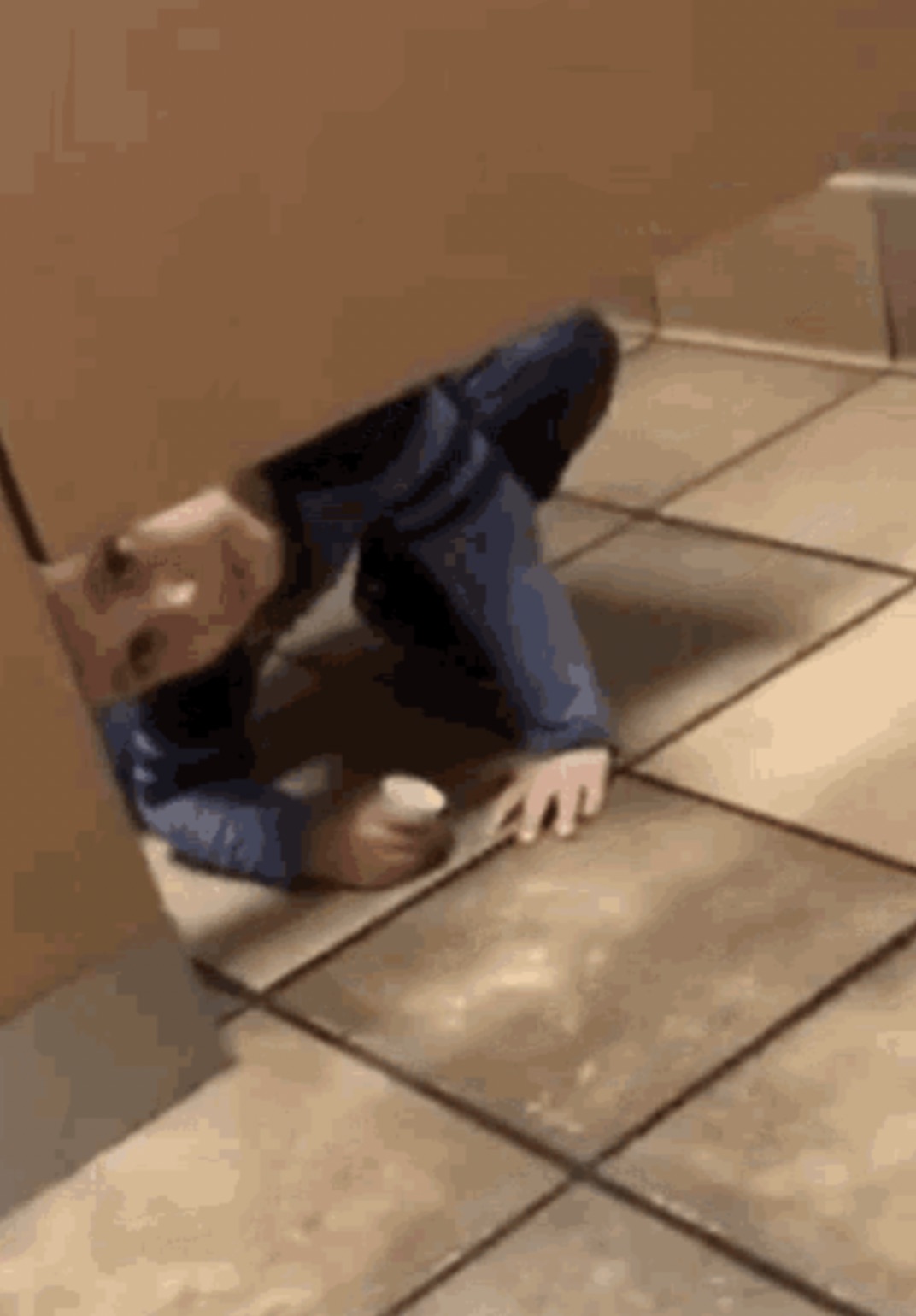 kid looking under bathroom stall