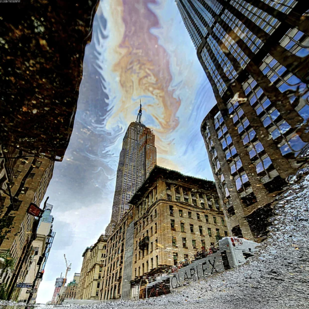 building reflected off of puddle