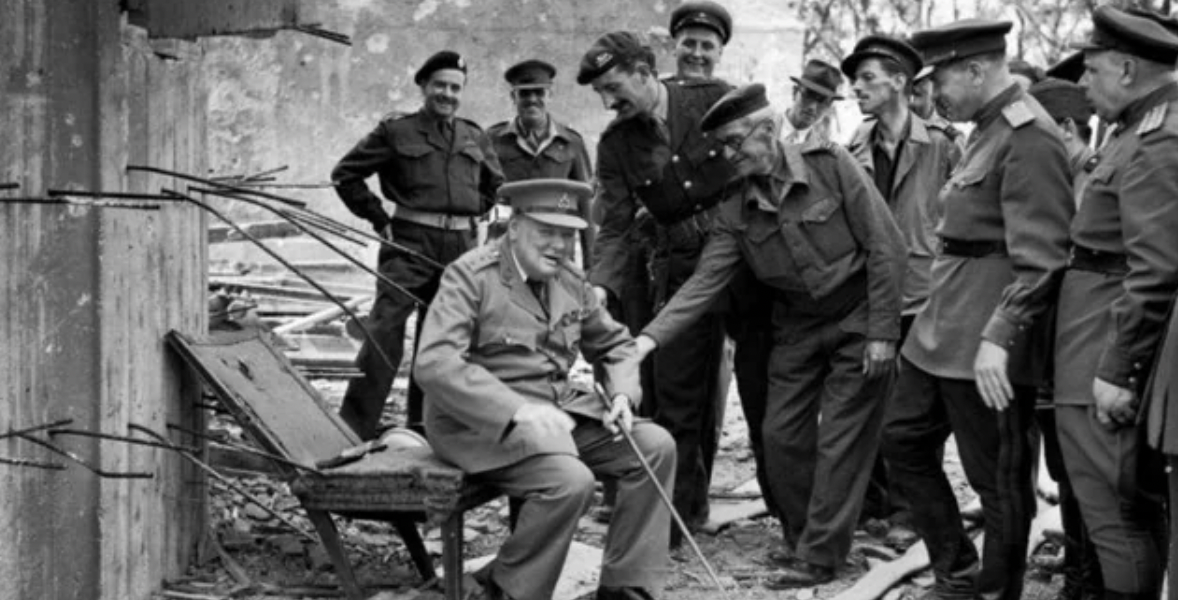 Winston Churchill sitting on Hitler's armchair, 1945.