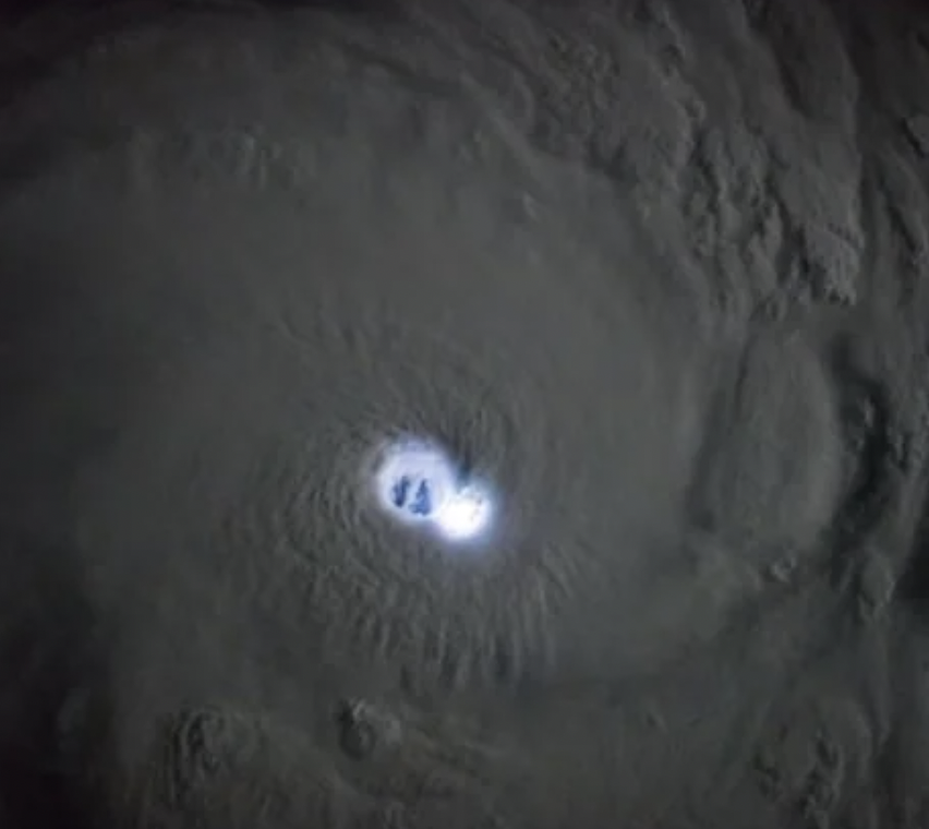 The eye of a tropical cyclone illuminated by lightning strikes captured from the ISS.