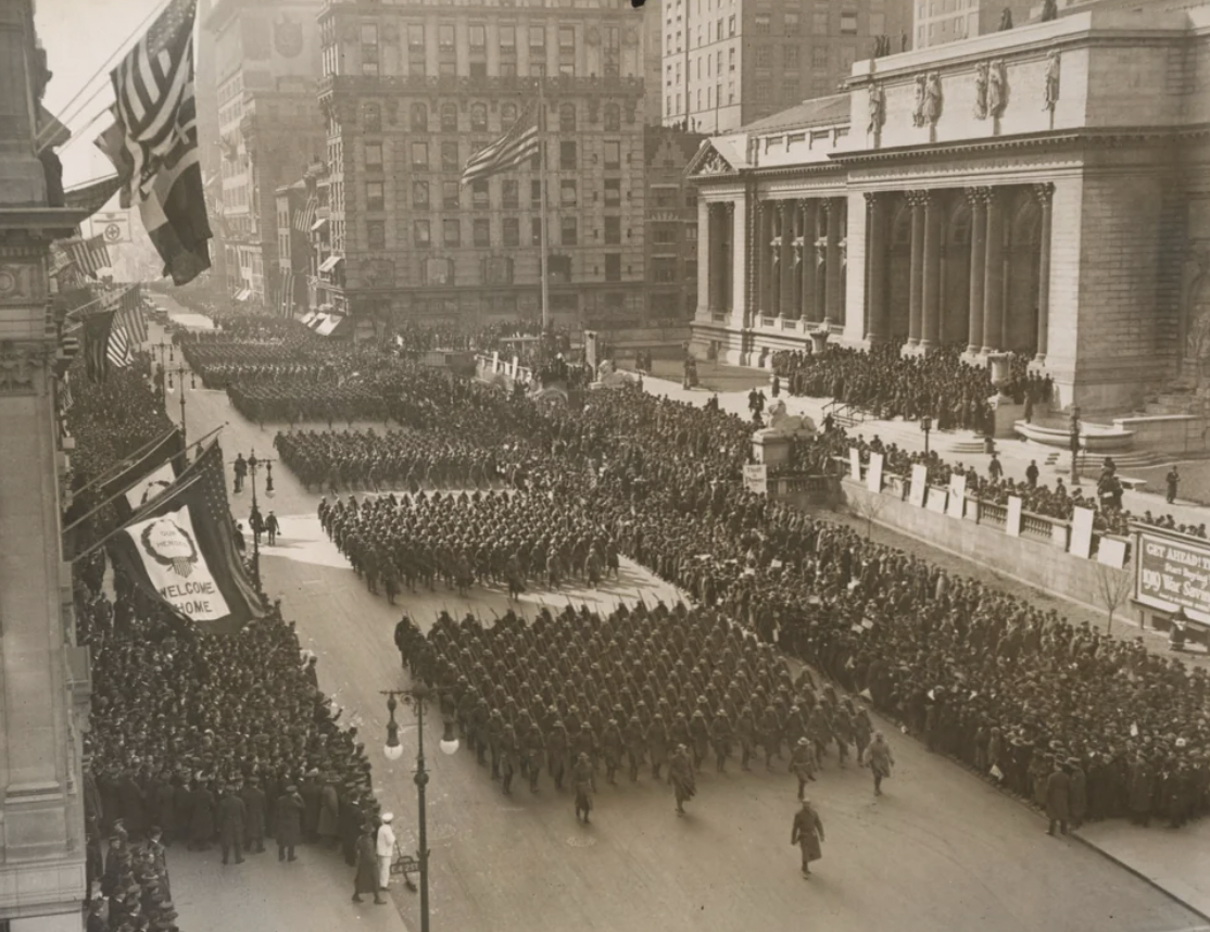 Returning soldiers from World War One of the 369th Infantry Regiment, aka the Harlem Hellfighters, parade up Fifth Avenue in New York City on Feb. 17, 1919.