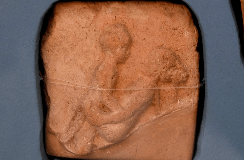 Terracotta plaque of couple having sex