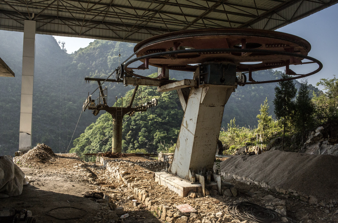 “The partially constructed terminus of a cable car that was scheduled to open last year, in Zhongdong, China. Built by a private investor with an eye towards making it easier for tourists to reach the Zhong cave, the cable car would have cut the roughly one-mile, one-hour hike to the village significantly. Some local residents say that the investor ran out of money, halting the project's completion.”