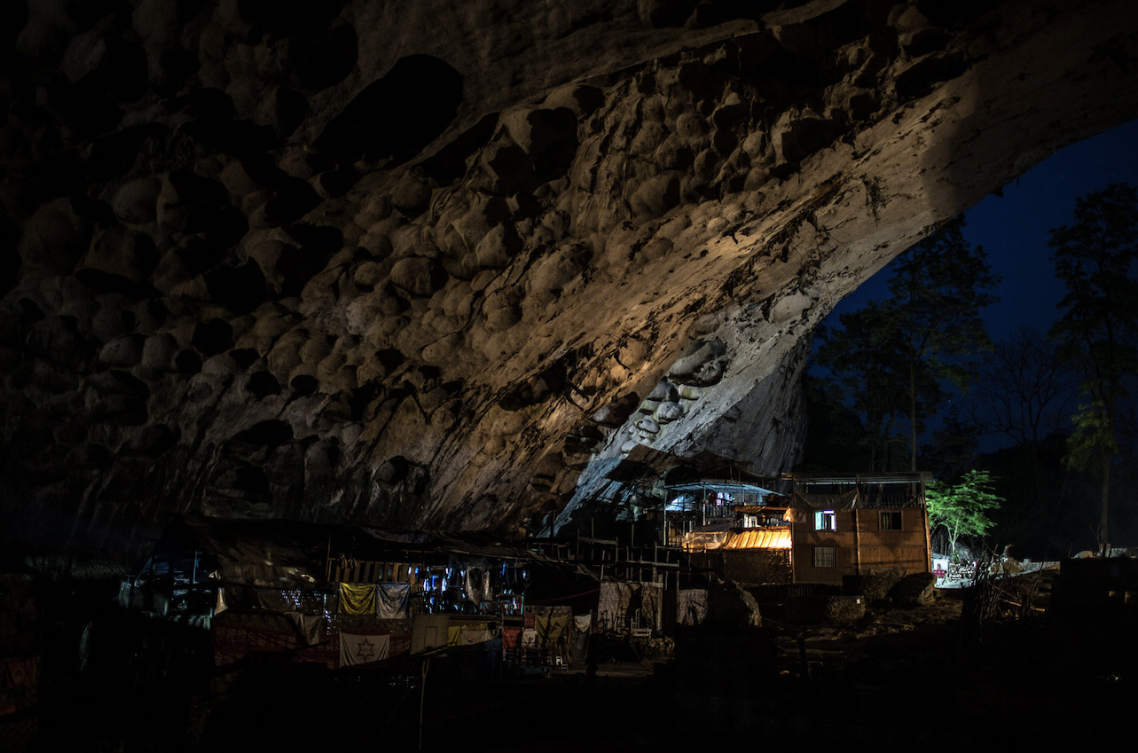 “The interior of the Zhong cave illuminated by resident's electric lights after sunset.” These were donated by an American visitor. 