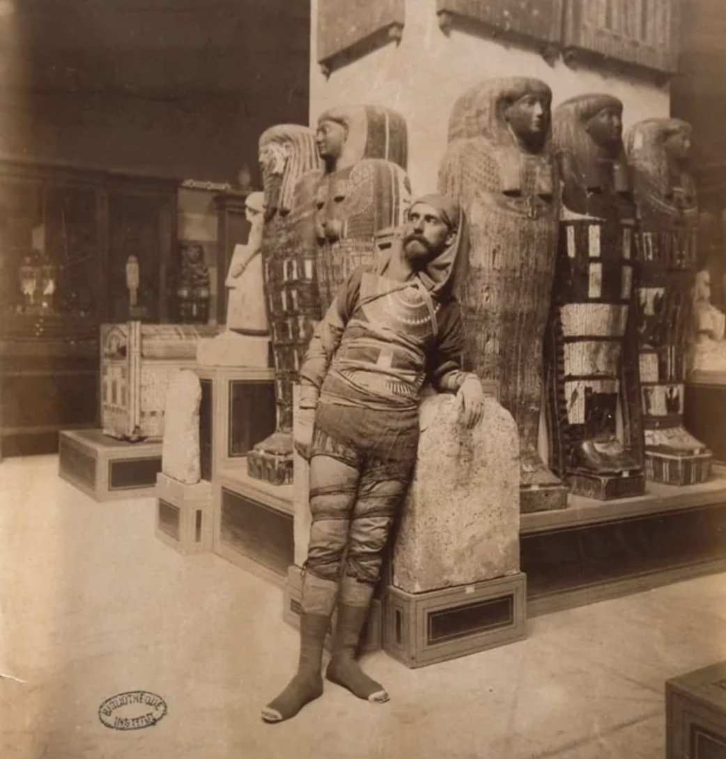 Spanish Egyptologist Eduardo Toda y Güell, who discovered and opened the intact tomb of Sennedjem, standing next to the ancient Egyptian mummies in the Bulak Museum. Filmed in 1885.