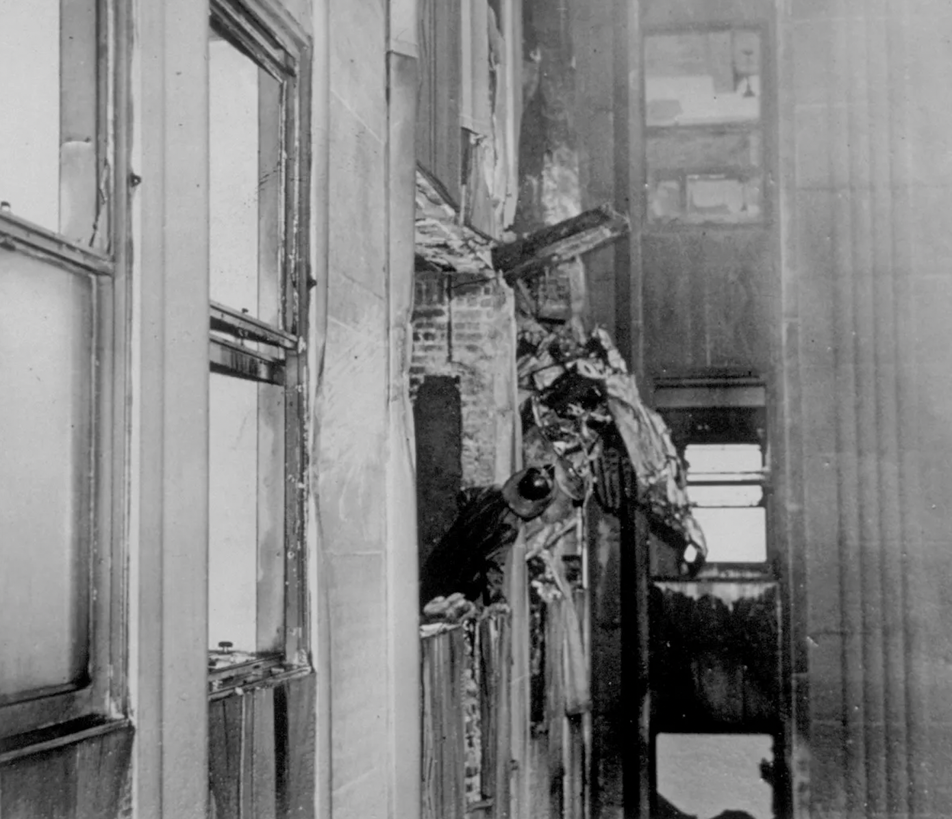 A part of the bomber hangs off the side of the building. 