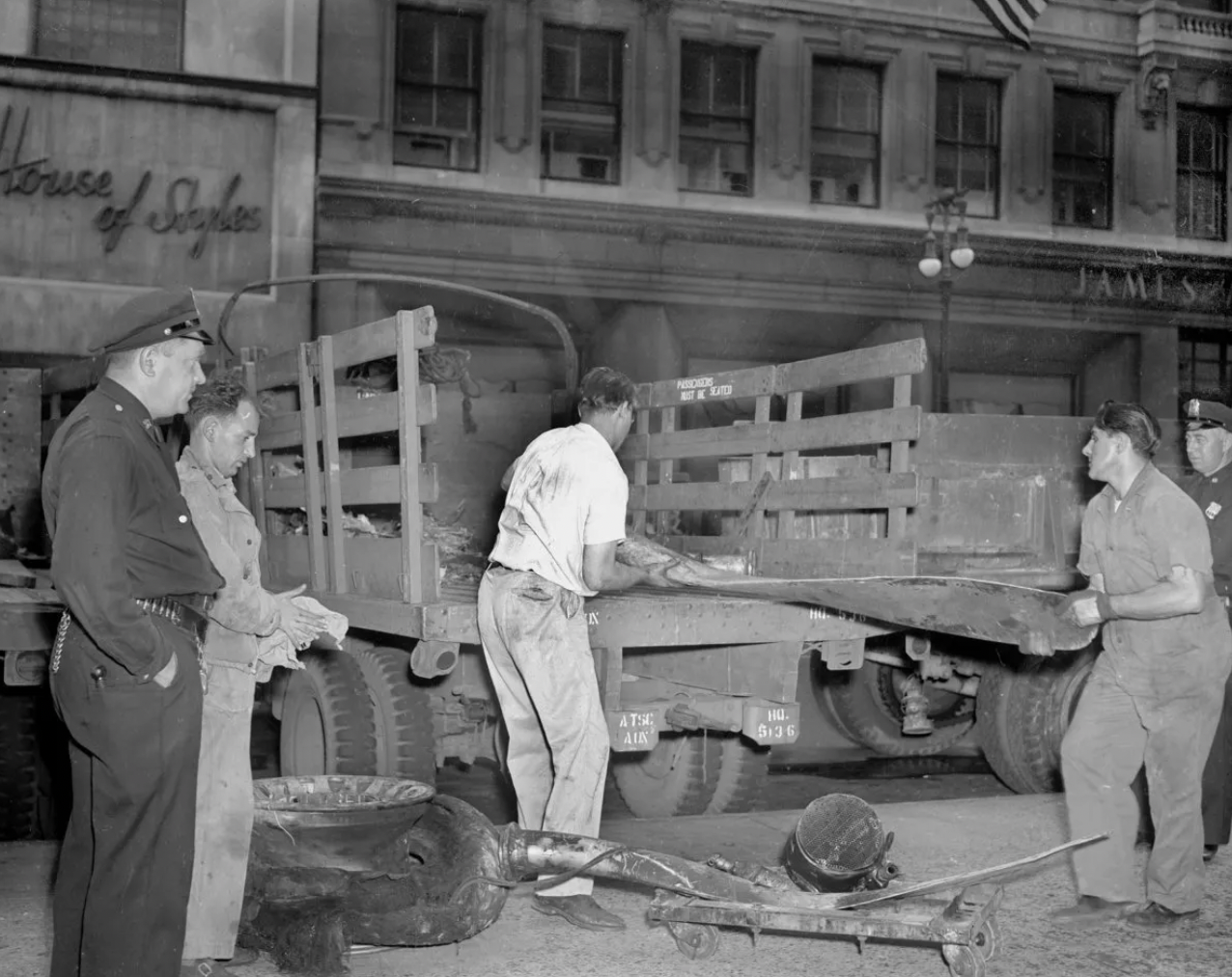 Workmen load pieces from the crashed plane onto a truck.