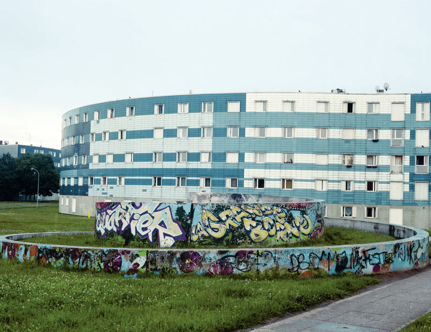 “The outer suburbs of Paris. It's really, really grim and depressing. Run down buildings that all look the same.”