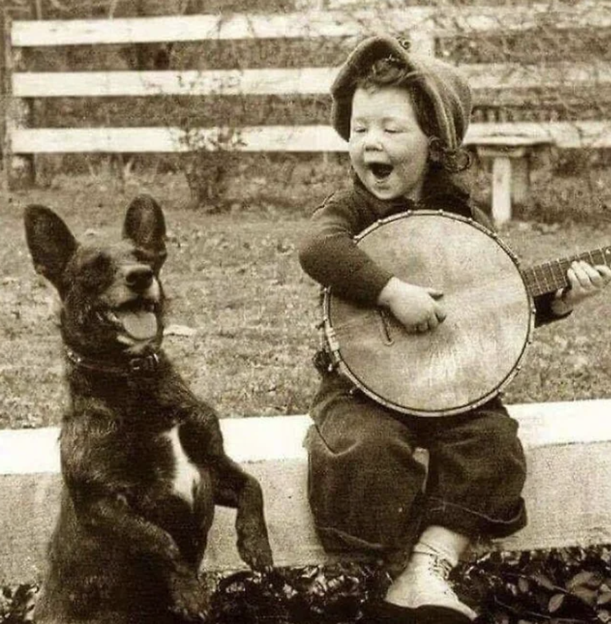 boy playing banjo with dog