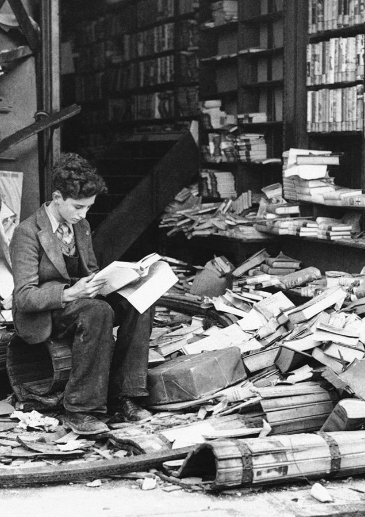 boy sits reading london 1940