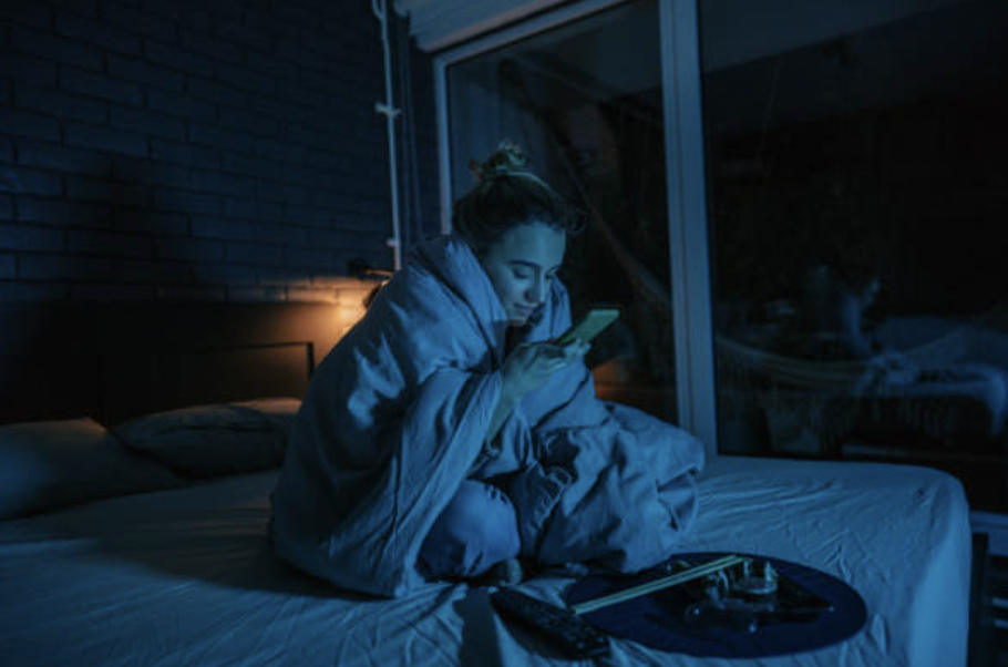 girl texting in bed at night