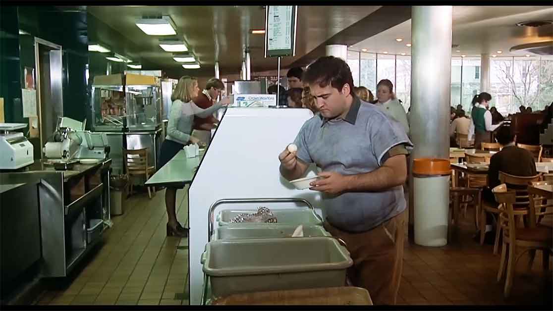 In a small gag, Bluto briefly stops flirting with women to take a bite out of a gold ball he finds in the food trash. He proceeds to eat an unholy amount of food throughout the rest of the scene. 