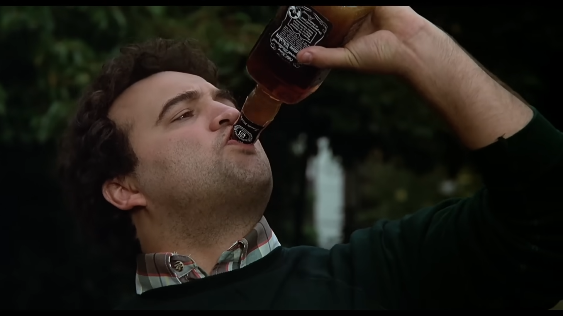 After yelling distraughtly that “they took the bar,” Bluto happily downs an entire bottle of Jack Daniels.