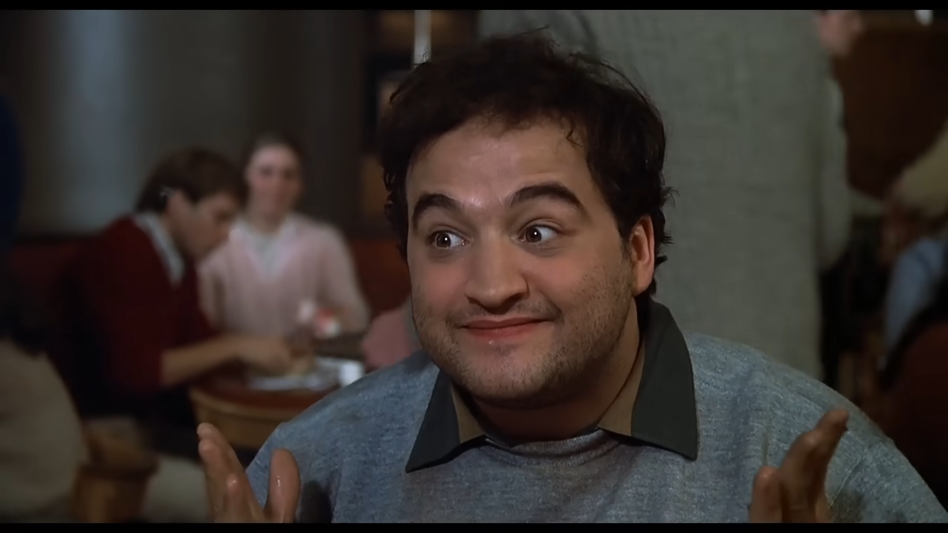 After stuffing his face with food, and being called a “P. I. G.,” Bluto fills his mouth with food, and smashes his cheeks, like popping a zit. He also spits all over Marmalard, starting a chase and a fight. 