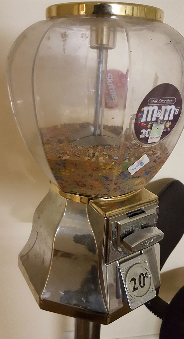 This candy dispenser is so old the candy inside of it has all but turned to dust.