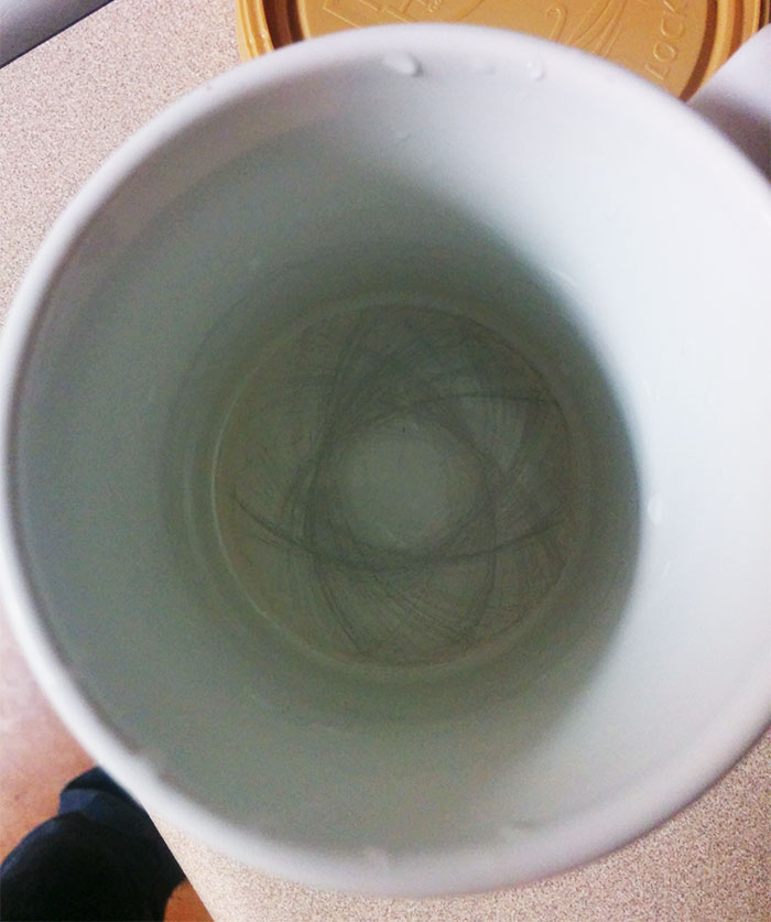 A cool fractal pattern that has emerged in the bottom of a coffee mug from years of stirring with a spoon.