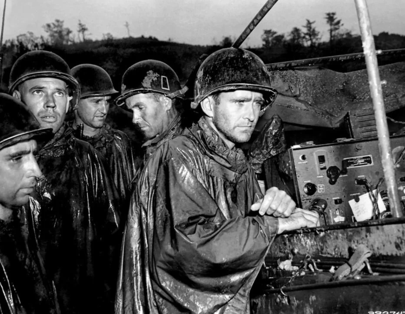 US Marines in Okinawa listen to the news of Germany's surrender in Europe on their radio during WW2, 1945. They would have to continue fighting. 