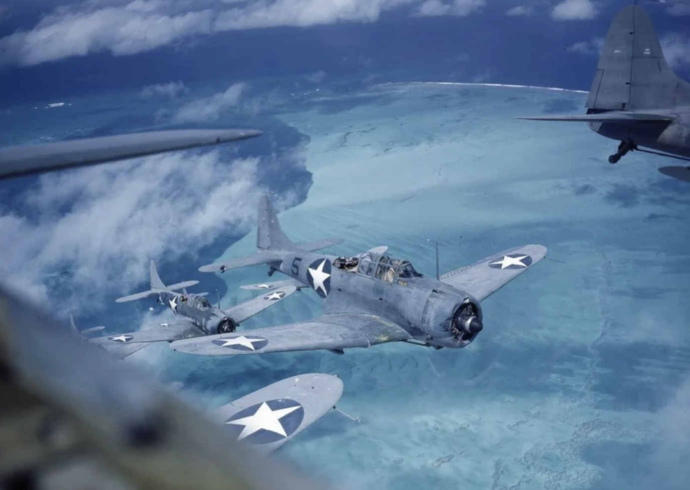 Douglas SBD Dauntless dive bombers over the Pacific during 1943, colorized. 