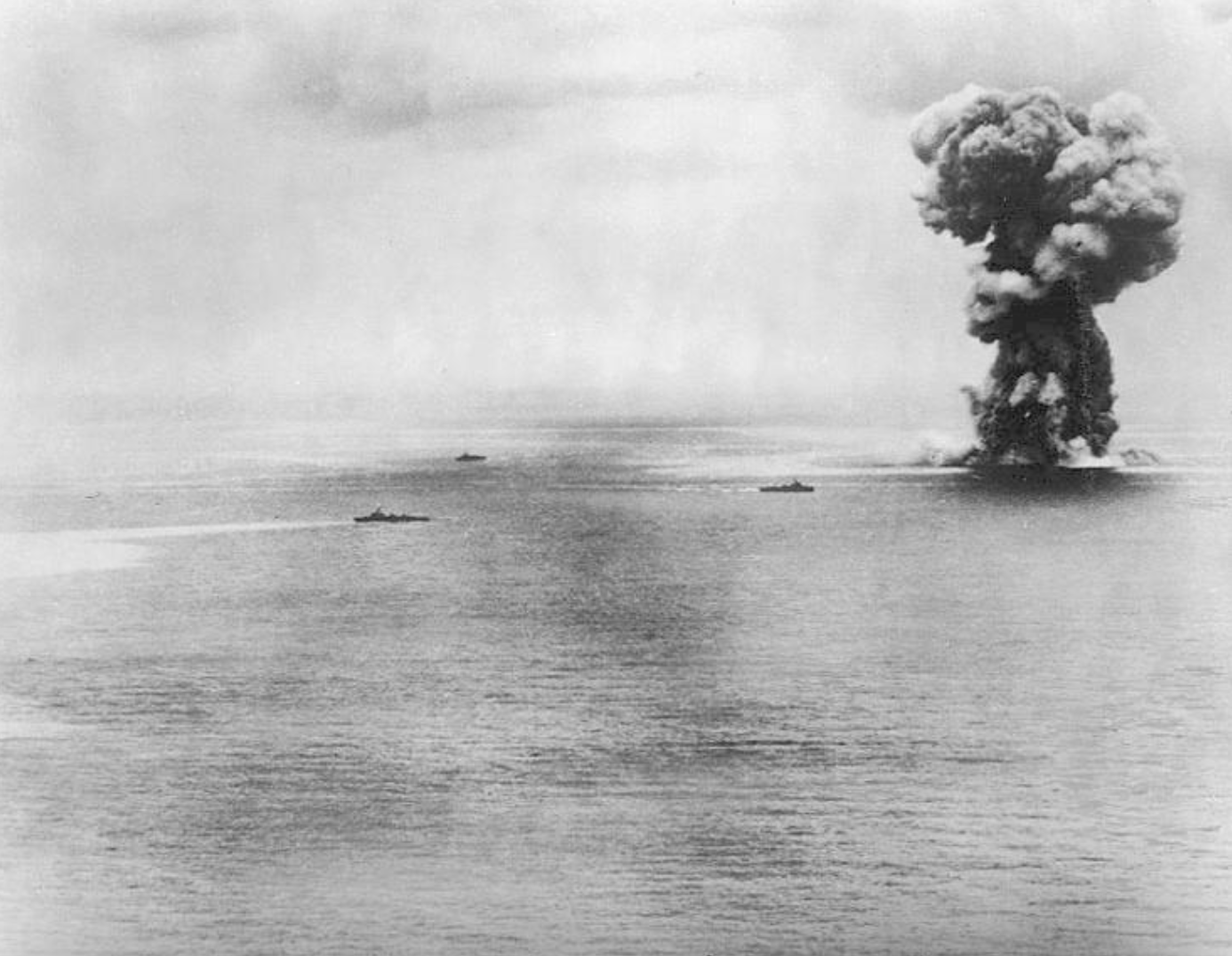 Japanese super battleship Yamato comes to a violent end after being attacked by 380 American carrier-based aircraft. Her escorting destroyers are pictured at left. 1945.