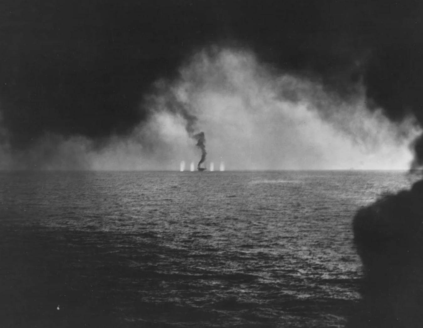 Carrier USS Gambier Bay is straddled by Japanese shellfire as she falls out of formation during the Battle Off Samar. October 25, 1944.