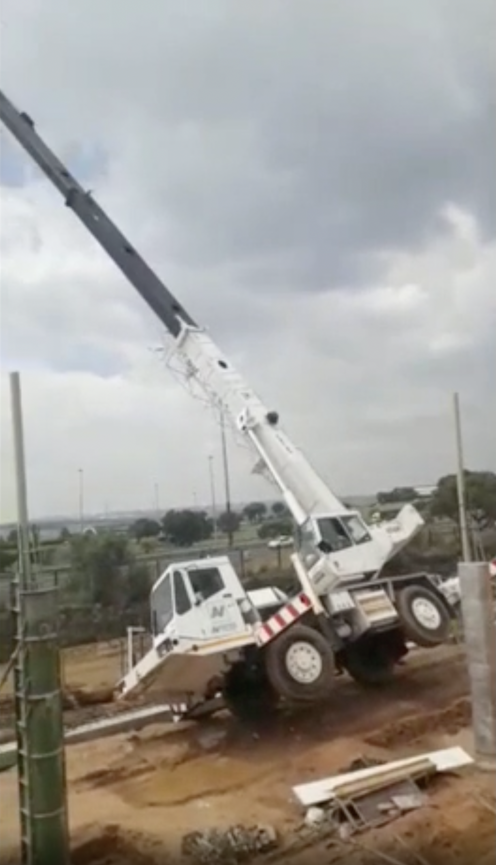 Unstable construction crane topples over.