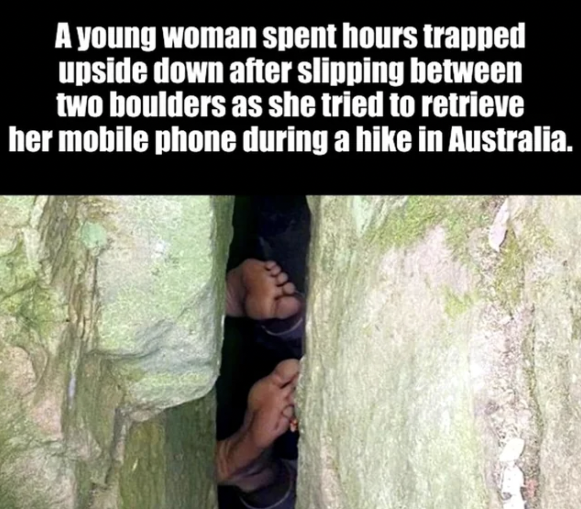 photo caption - A young woman spent hours trapped upside down after slipping between two boulders as she tried to retrieve her mobile phone during a hike in Australia.