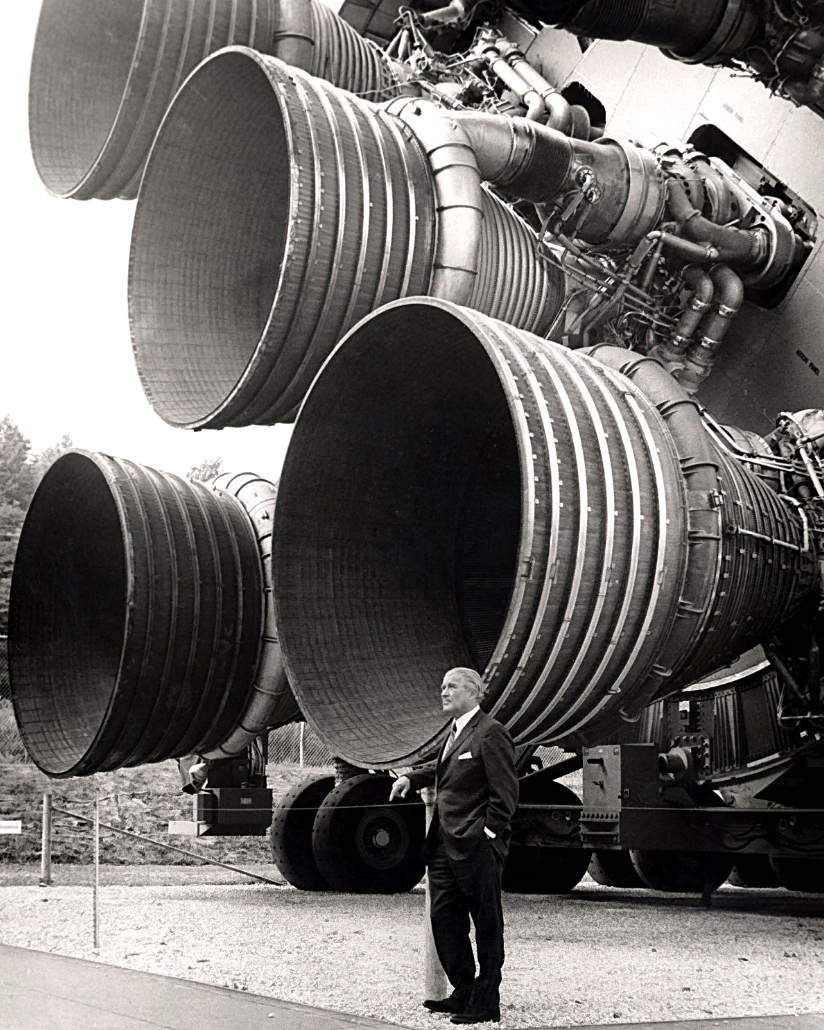 Dr. von Braun stands by the five F-1 engines of the Saturn V Dynamic Test Vehicle on display at the U.S. Space and Rocket Center in Huntsville, Alabama. The engines measured 19-feet tall by 12.5-feet at the nozzle exit. 1960s.