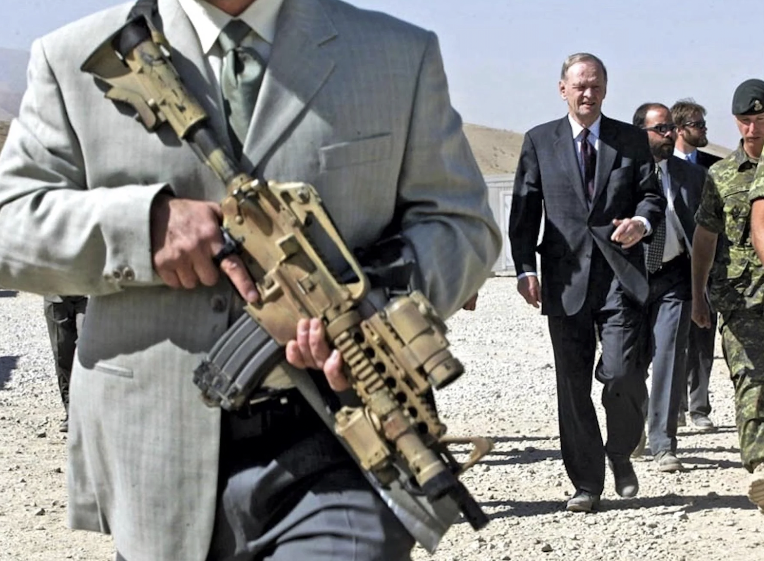 JTF-2 commandos in sunglasses and business suits accompanied then-prime minister Jean Chrétien as he visited Canadian troops at Camp Julien Kabul, Afghanistan. 2003