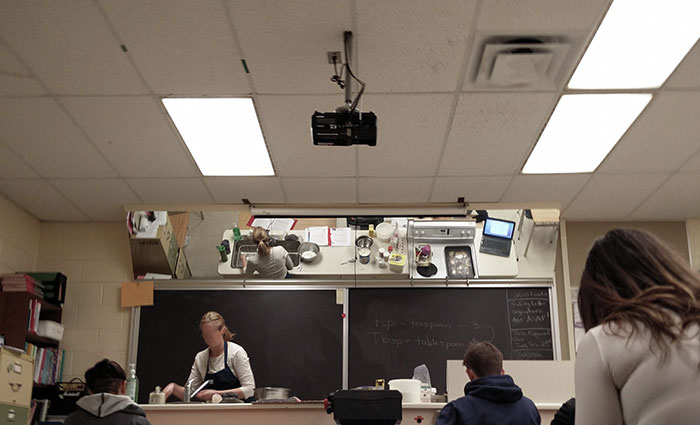 The culinary class at this school has a mirror mounted on the ceiling at an angle so students can see what the instructor is doing.