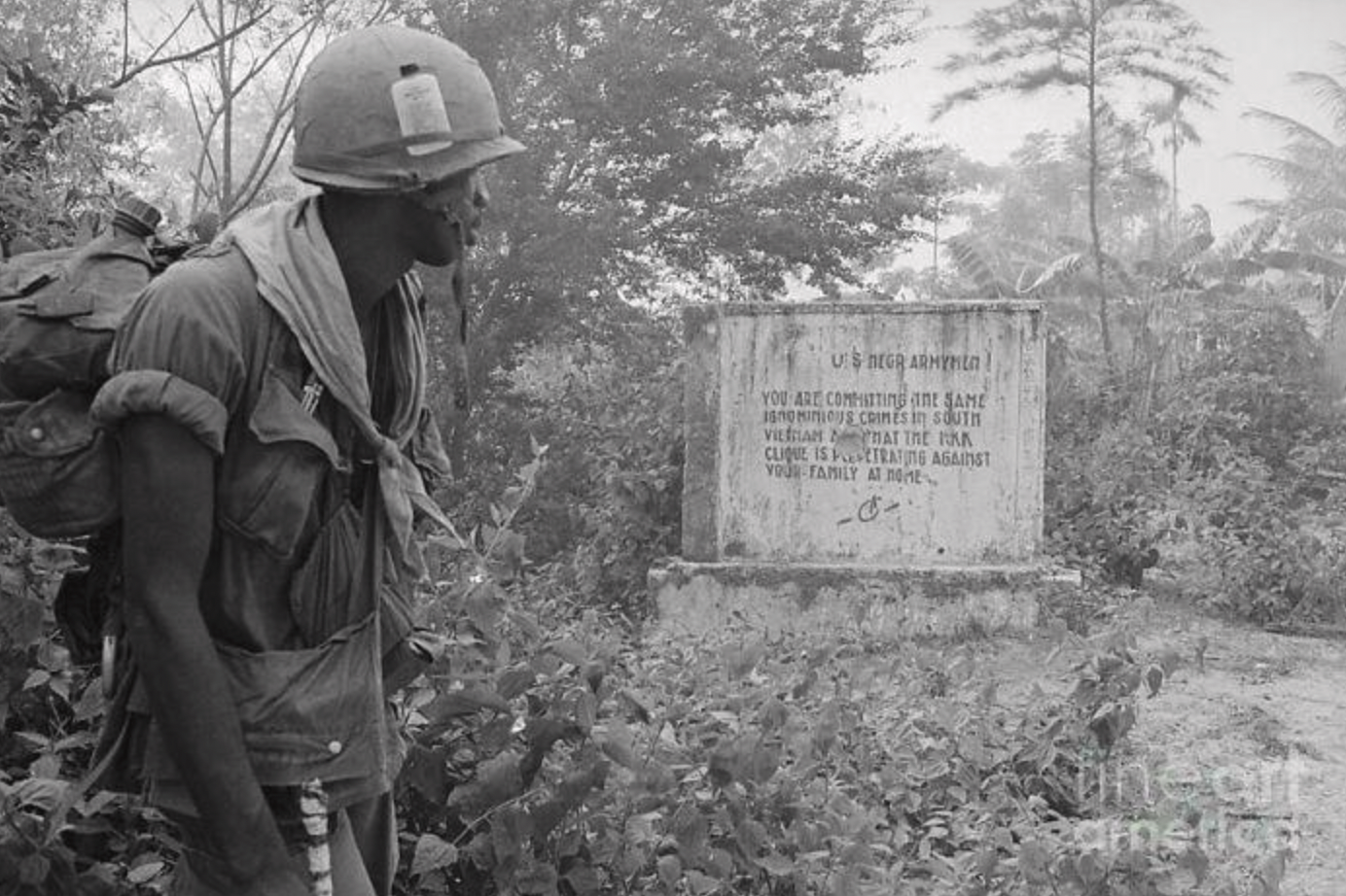 A black U.S. soldier reads a message left by the Viet Cong during the Vietnam War, the message reads: "U.S. Negro Armymen, You Are Committing The Same Ignominious Crimes In South Vietnam That The KKK Clique Is Perpetrating Against Your Family At Home.” 1970.