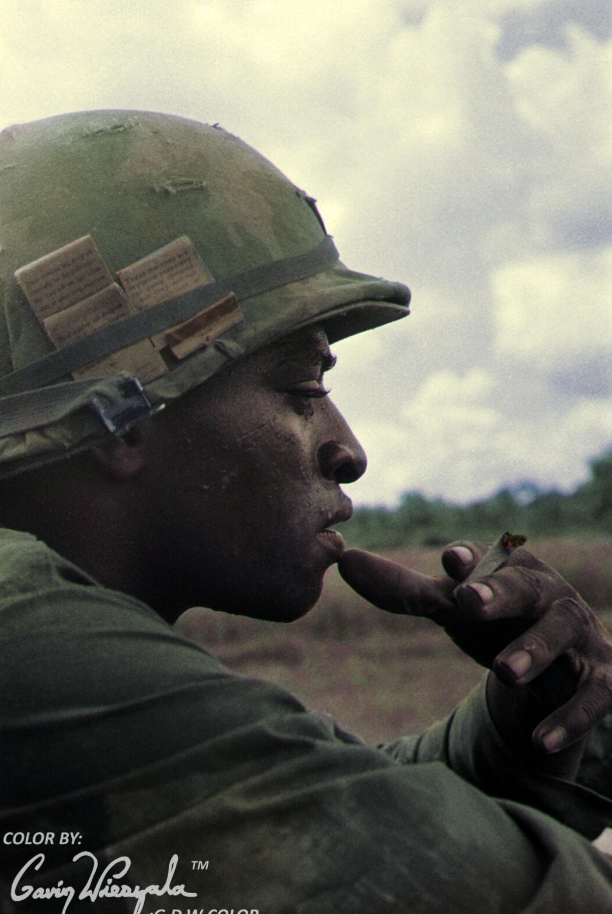 An unidentified soldier of the 25th Infantry Division pauses for a cigarette. Vietnam War, 1969, colorized. 