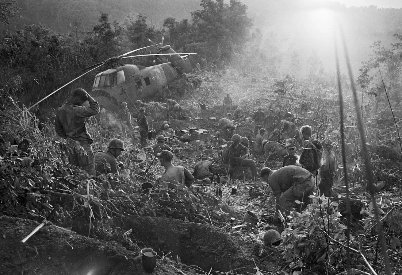 Marines emerge from their foxholes south of the DMZ after a third night of fighting against North Vietnamese troops in September 1966.