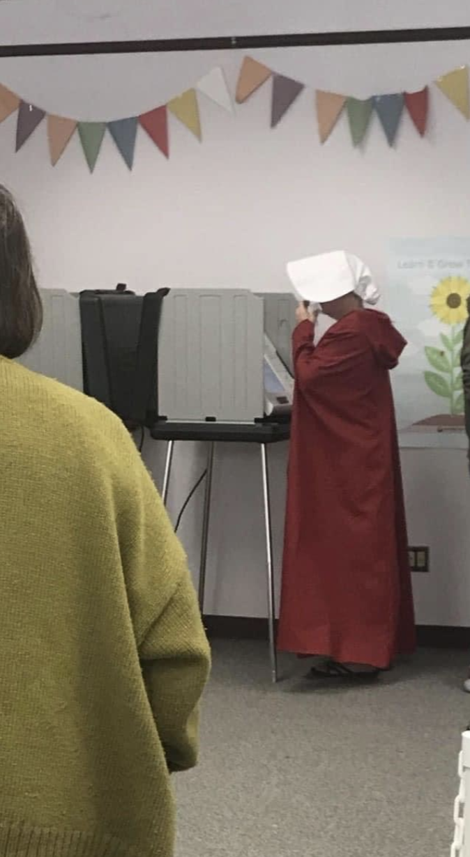 Woman dressed as 'Handmaid' votes in Asheville, North Carolina.