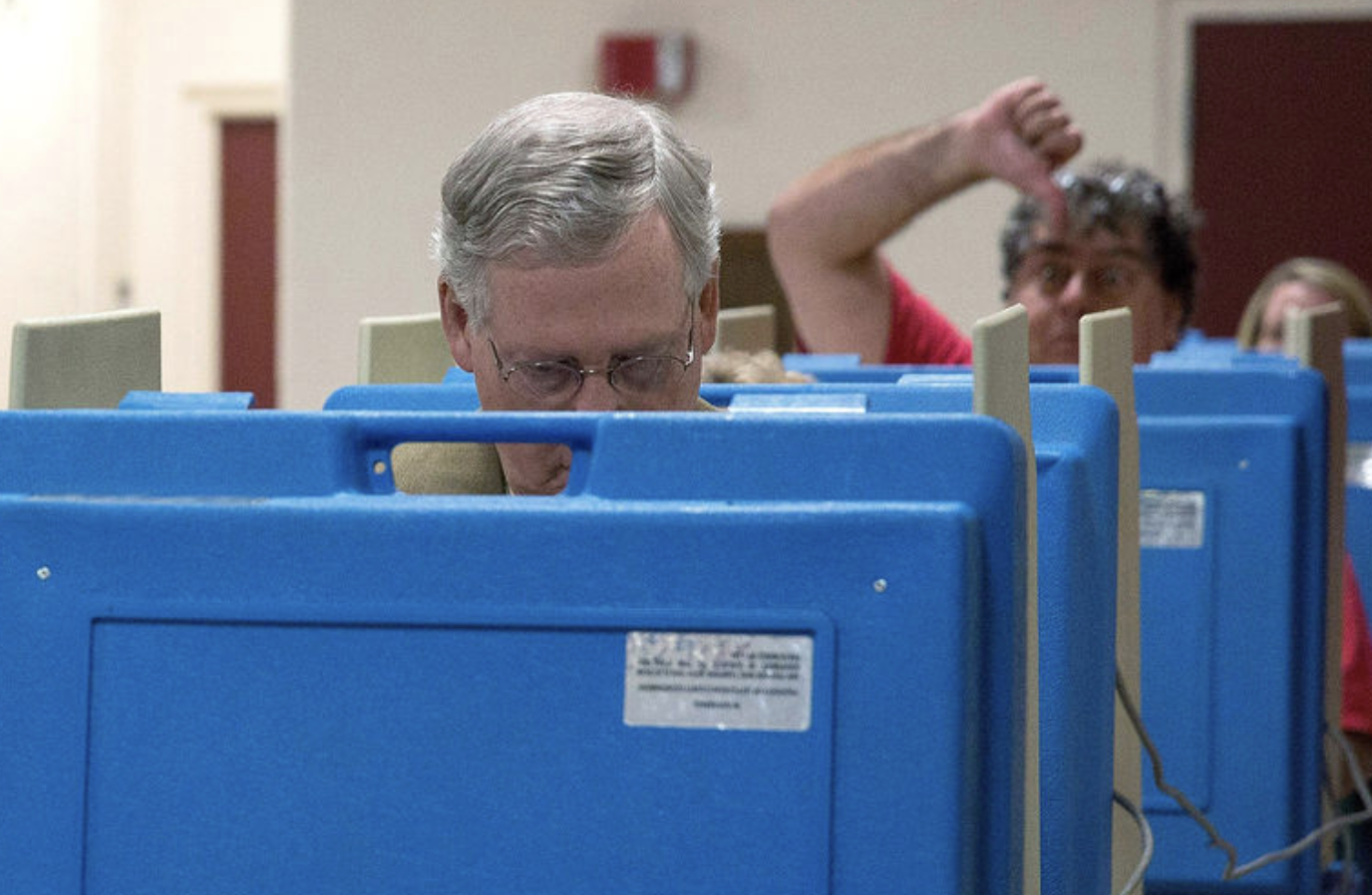 Mitch McConnell’s vote photobombed by unhappy constituent.