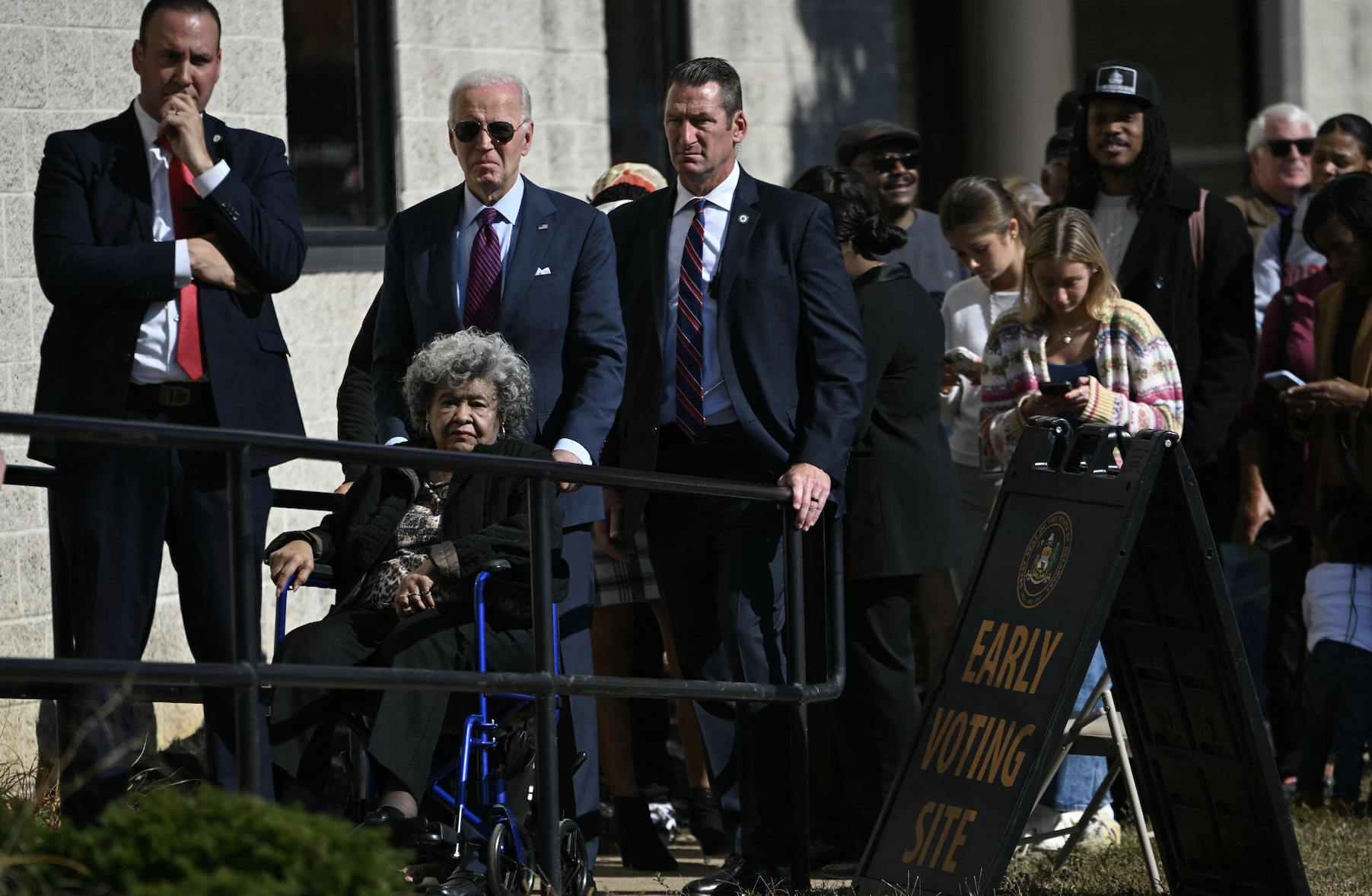 President Joe Biden waits in line with voters outside a polling station in New Castle, Delaware.