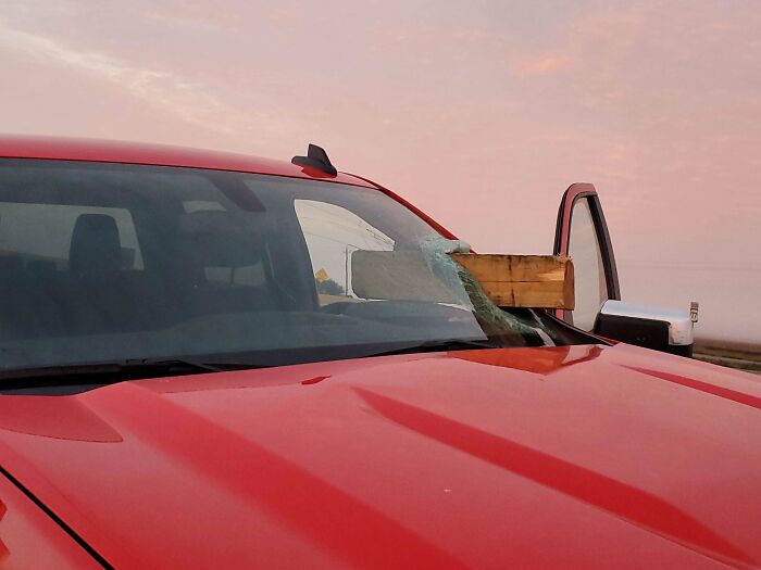 This lucky guy almost had a final destination moment on their commute to work when a board flew through their windshield on the driver's side.