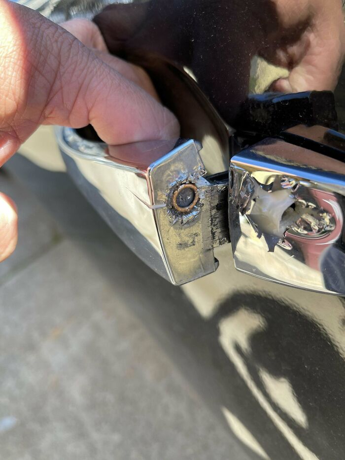 A stray bullet this this guy's car door handle.