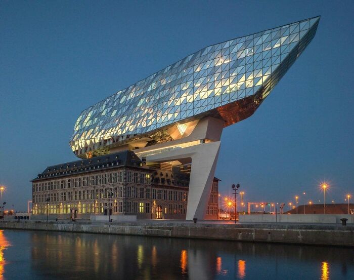 The Port Authority building in Antwerp Belgium looks like a glass ship that might take off into the sky.