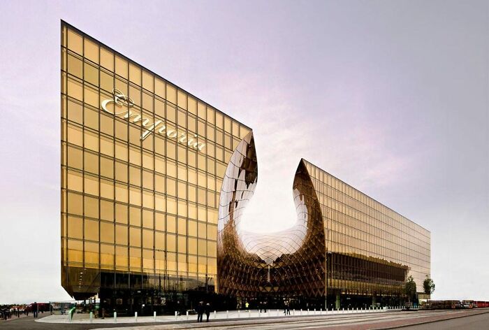 This building is the Grand Shopping Center in Malmo, Sweden, looks like a giant NASA solar panel that got hit by a meteor, or giant space bullet.