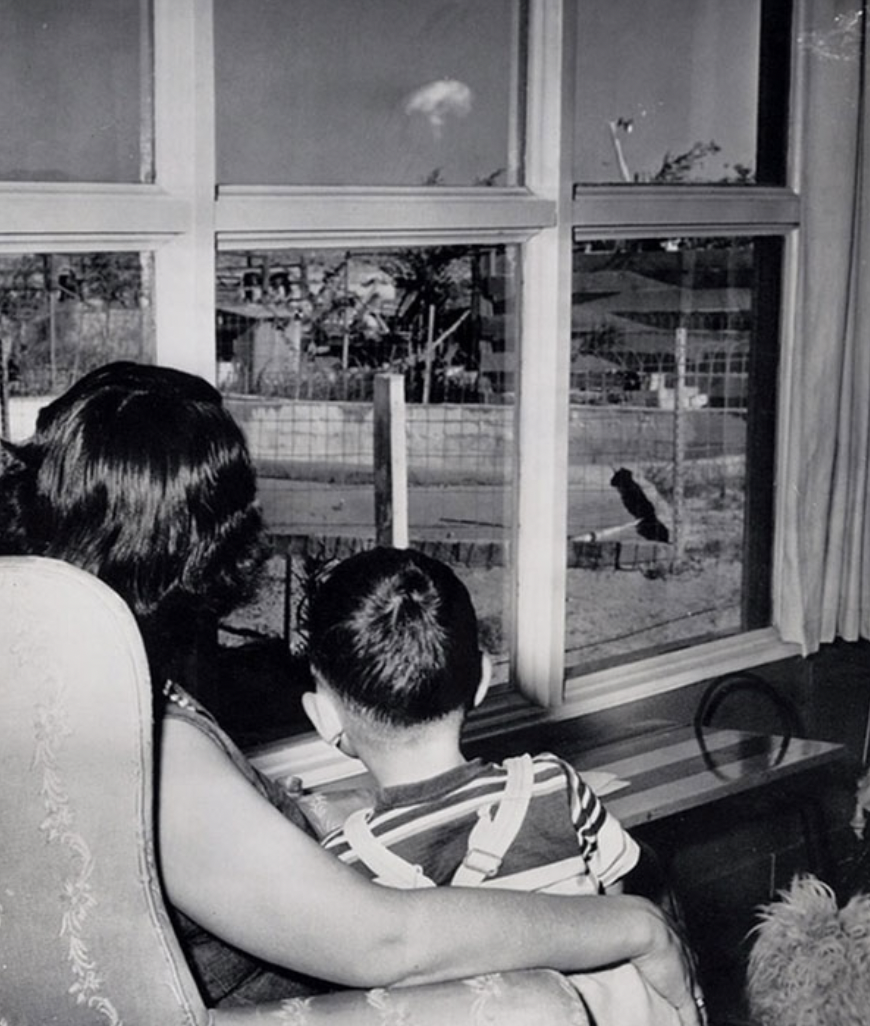 mother and son watching the mushroom cloud after an atomic test las vegas 1953