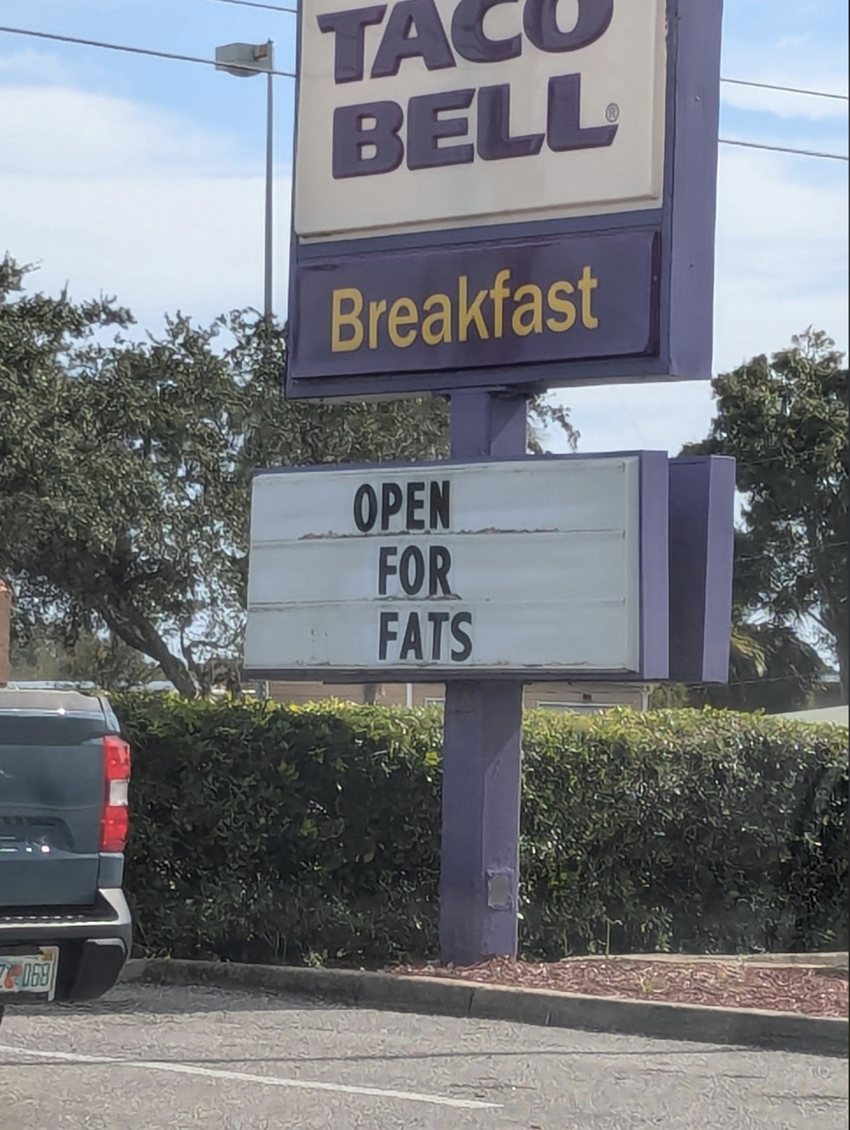 street sign - Tac Bell Breakfast Open For Fats